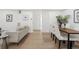 Bright living room with modern décor, light wood floors and a dining area perfect for entertaining at 252 N Pennsylvania St # 102, Denver, CO 80203