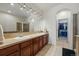 Lovely bathroom featuring double sinks, a large mirror, and a walk-in shower with tiled surround at 11307 Navajo Cir # A, Westminster, CO 80234