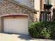 Attached garage with a neutral-colored door and manicured bushes at 11307 Navajo Cir # A, Westminster, CO 80234