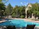 Community pool surrounded by lounge chairs and lush landscaping at 11307 Navajo Cir # A, Westminster, CO 80234