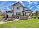 A beautiful home exterior featuring a spacious backyard with a hot tub, fire pit, and outdoor dining at 703 Tiger Lily Way, Highlands Ranch, CO 80126