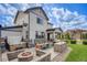 Backyard patio with outdoor seating, grill area, fire pit, hot tub and green lawn at 703 Tiger Lily Way, Highlands Ranch, CO 80126