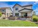 The back of this beautiful home features a spacious backyard with a gas grill and outdoor seating at 703 Tiger Lily Way, Highlands Ranch, CO 80126