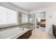 Bright bathroom with a soaking tub, a glass-enclosed shower, and a view to the main bedroom at 703 Tiger Lily Way, Highlands Ranch, CO 80126