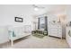 Bright bedroom with a crib, a dresser, and neutral-toned decor at 703 Tiger Lily Way, Highlands Ranch, CO 80126