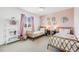 Charming pink bedroom featuring twin beds, decorative mirrors, and stylish decor at 703 Tiger Lily Way, Highlands Ranch, CO 80126