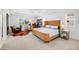 Bright bedroom with large windows, a cozy sitting area and a stylish rattan bed frame at 703 Tiger Lily Way, Highlands Ranch, CO 80126