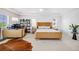 Airy bedroom featuring large windows, a rattan bed frame, and a dedicated work space at 703 Tiger Lily Way, Highlands Ranch, CO 80126