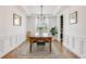 Elegant dining room with stylish lighting, wainscoting, and a view of the backyard at 703 Tiger Lily Way, Highlands Ranch, CO 80126