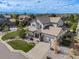 A front aerial view of a beautiful home, a well-manicured lawn, and a tree-lined neighborhood at 703 Tiger Lily Way, Highlands Ranch, CO 80126