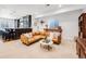 Inviting living room with comfortable seating, a stylish bar, and ample natural light at 703 Tiger Lily Way, Highlands Ranch, CO 80126