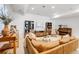 Spacious, well-lit living room with cozy furniture, piano, and stylish decor at 703 Tiger Lily Way, Highlands Ranch, CO 80126