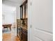 Butler's pantry featuring dark wood cabinets, granite countertops, and modern appliances at 703 Tiger Lily Way, Highlands Ranch, CO 80126