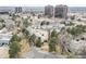 A high-angle aerial shot of a neighborhood featuring apartments, trees, and tall office buildings at 2754 S Kenton Ct, Aurora, CO 80014