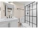 White bathroom with modern vanity, updated shower with matte black accents at 2754 S Kenton Ct, Aurora, CO 80014
