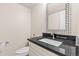 Elegant half bath features decorative mirror and granite vanity at 2754 S Kenton Ct, Aurora, CO 80014