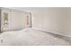 Spacious room with light carpet, base trim, and two windows with views at 2754 S Kenton Ct, Aurora, CO 80014
