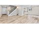 Open-concept space featuring modern staircase, hardwood floors, and ample natural light at 2754 S Kenton Ct, Aurora, CO 80014