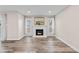 Cozy living room with fireplace, complemented by hardwood floors and natural light at 2754 S Kenton Ct, Aurora, CO 80014