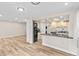 Open floor plan showing modern kitchen and spacious living area with hardwood floors at 2754 S Kenton Ct, Aurora, CO 80014