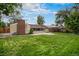 This backyard boasts mature trees, a brick chimney, and a private outdoor space at 4906 E Bates Ave, Denver, CO 80222