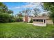 Large grassy backyard features mature trees, offering shade and privacy at 4906 E Bates Ave, Denver, CO 80222
