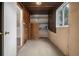 Unfinished basement has shelving and a window for natural light, offering potential at 4906 E Bates Ave, Denver, CO 80222