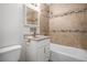 The remodeled bathroom has stylish tile work, a modern vanity, and updated fixtures at 4906 E Bates Ave, Denver, CO 80222