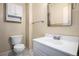 Bathroom featuring toilet and sink with overhead vanity and chrome hardware at 4906 E Bates Ave, Denver, CO 80222