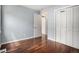 Bedroom featuring hardwood floors, ample closet space and a large window at 4906 E Bates Ave, Denver, CO 80222