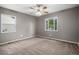 Spacious bedroom with neutral tones, two windows and a ceiling fan at 4906 E Bates Ave, Denver, CO 80222