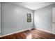 This bedroom features wood floors and a window providing natural light at 4906 E Bates Ave, Denver, CO 80222