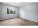 Bedroom with large window providing ample natural light and views of greenery at 4906 E Bates Ave, Denver, CO 80222