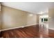 Spacious living room with hardwood floors and natural light from adjacent sunroom at 4906 E Bates Ave, Denver, CO 80222