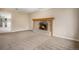 Inviting living room featuring a stone fireplace with wooden mantle, and neutral carpeting at 4906 E Bates Ave, Denver, CO 80222
