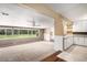 Bright living room featuring expansive windows for plenty of natural light and access to the kitchen at 4906 E Bates Ave, Denver, CO 80222