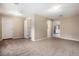 Spacious living room boasting neutral carpeting, and multiple doorways leading to other rooms at 4906 E Bates Ave, Denver, CO 80222