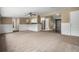 Open concept living room featuring neutral carpet, ceiling fan, and easy access to the kitchen with stainless appliances at 4906 E Bates Ave, Denver, CO 80222