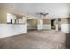 Open concept living room featuring neutral carpet, white walls and easy access to the kitchen at 4906 E Bates Ave, Denver, CO 80222