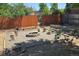 Gravel backyard featuring a circular fire pit and unique stump seating arrangement at 1920 Elmira St, Aurora, CO 80010