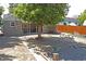Spacious backyard with established tree, picnic table, wood fence, and screened patio area at 1920 Elmira St, Aurora, CO 80010