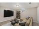 Cozy basement entertainment area with a comfortable sectional sofa and a large-screen TV for relaxing at 1920 Elmira St, Aurora, CO 80010