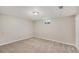 Spacious carpeted basement with ample room and natural light from a window at 1920 Elmira St, Aurora, CO 80010
