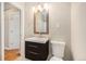 Bathroom with framed mirror and modern vanity with dark wood drawers and hardware at 1920 Elmira St, Aurora, CO 80010