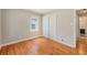 Bedroom with hardwood floors, double-door closet, window, base trim, and neutral-colored paint at 1920 Elmira St, Aurora, CO 80010
