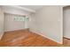Bright bedroom boasts wood flooring, closet, base trim, and neutral-colored paint at 1920 Elmira St, Aurora, CO 80010
