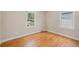 Bedroom with hardwood flooring, windows with white trim, and neutral-colored paint at 1920 Elmira St, Aurora, CO 80010
