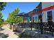 Modern building featuring a patio with seating, stylish railings, and a blue umbrella at 1920 Elmira St, Aurora, CO 80010