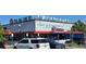 A commercial building with storefronts and ample parking, ideal for business owners and customers at 1920 Elmira St, Aurora, CO 80010
