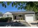 Charming home with a well-maintained lawn, bright chairs, and an attached garage at 1920 Elmira St, Aurora, CO 80010